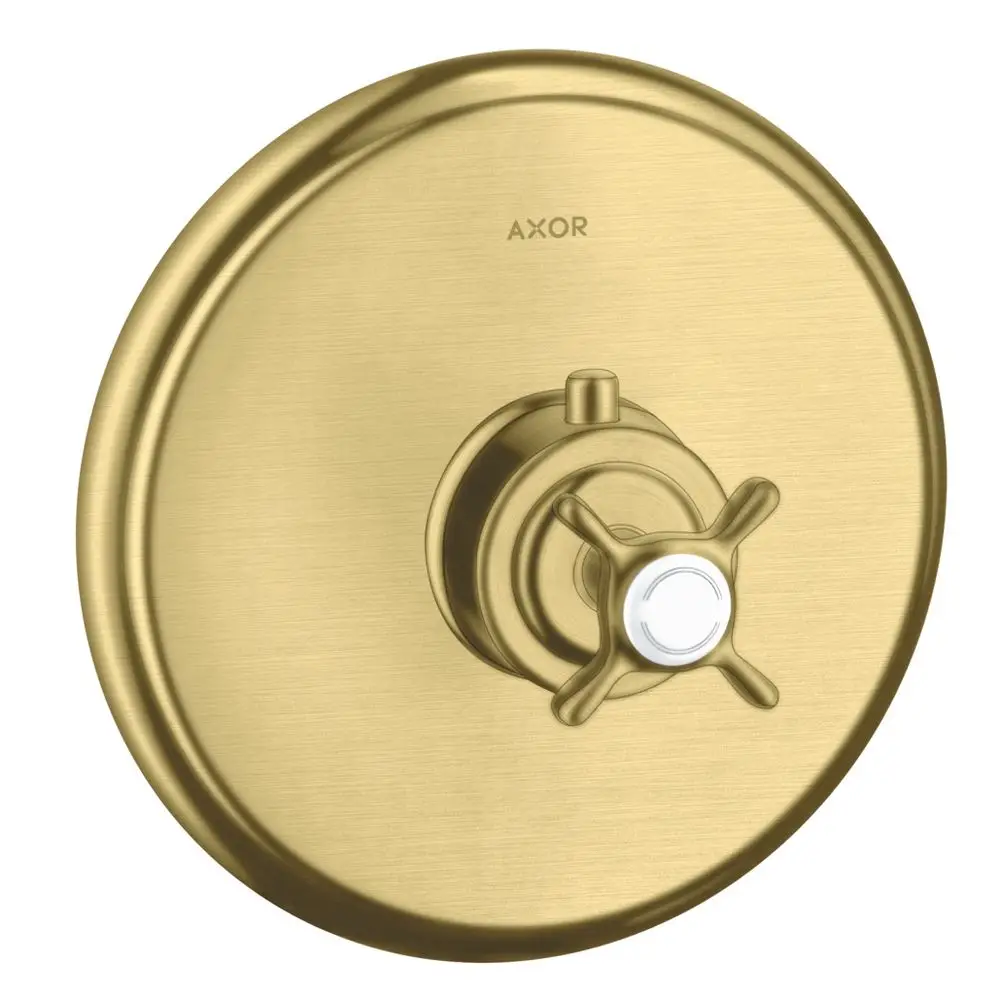 Thermostat für Wandmontage in gebürstetem Messing von AXOR mit Kreuzgriff. Runde Abdeckung und zentraler Drehmechanismus sind sichtbar.